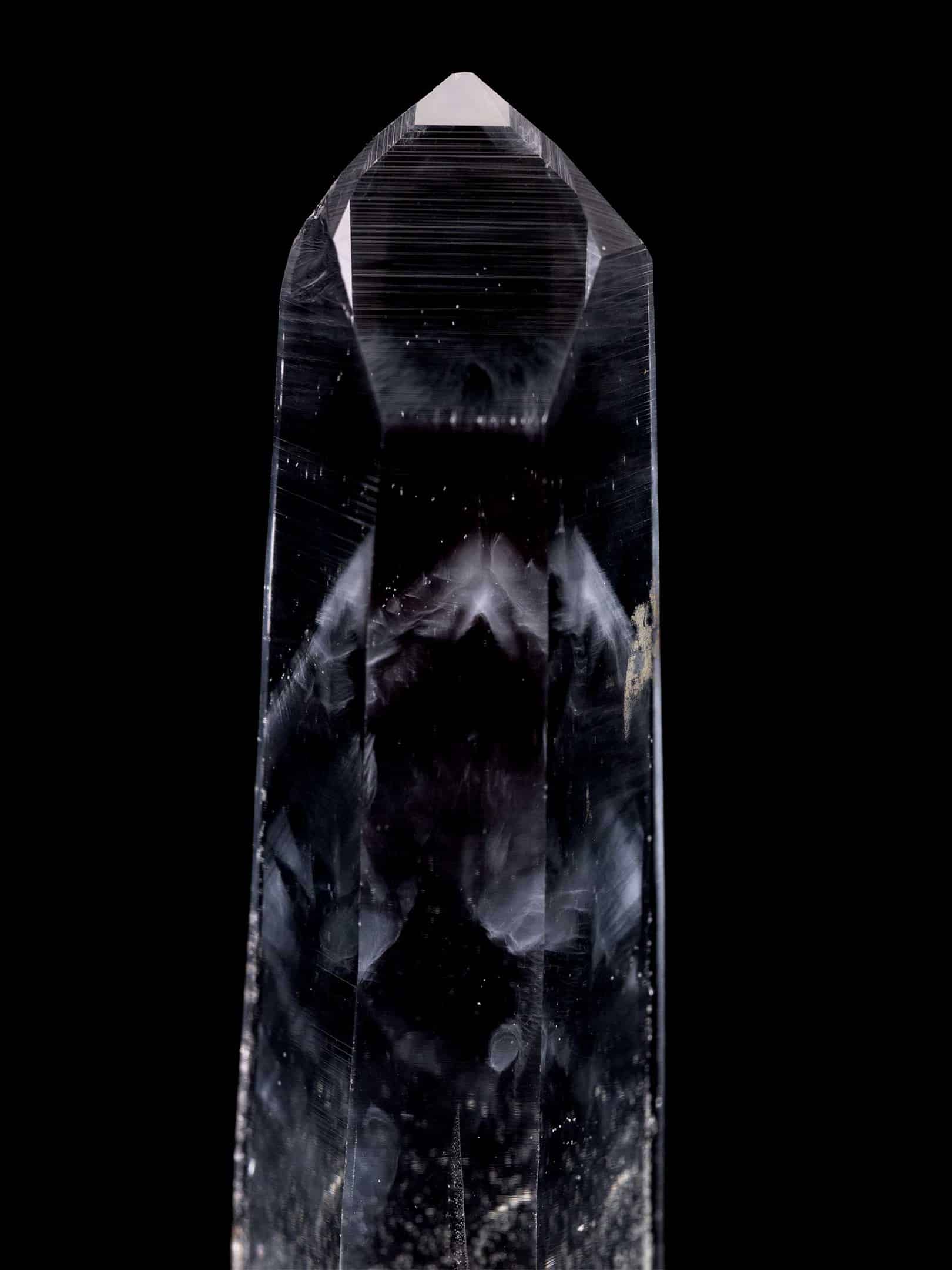 Close view of Colombian Blue Smoke Cookeite included Phantom Lemurian Silver Light Clear Quartz channel crystal showing the termination, side striations, and smoky phantom interior